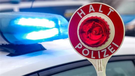 Ein Polizist hält eine Polizeikelle für eine Kontrolle hoch. (zu dpa: «15-Jähriger am Steuer rammt Verkehrsschild und Laterne»)
