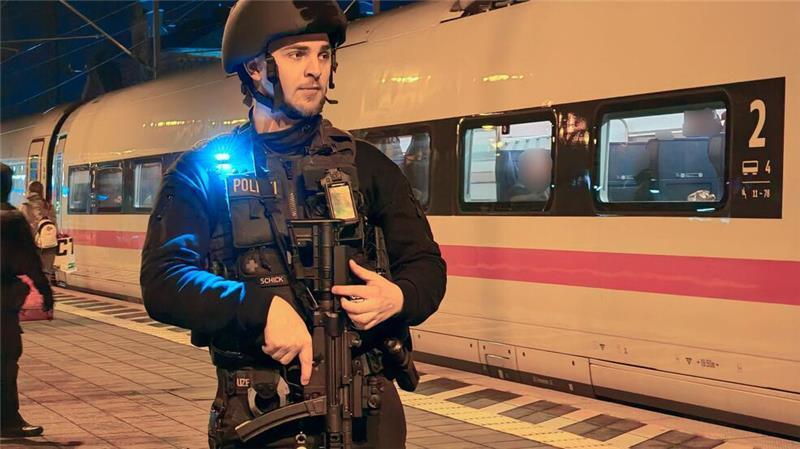 Ein Polizist steht auf dem Bahnsteig vor dem ICE in Elze.