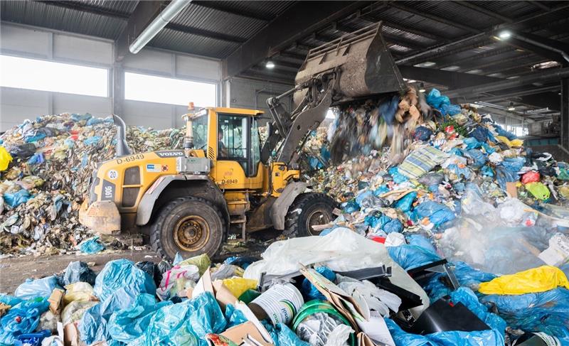 Ein Radlader schiebt Restmüll in einer Deponie zusammen. Foto: Julian Stratenschulte/dpa