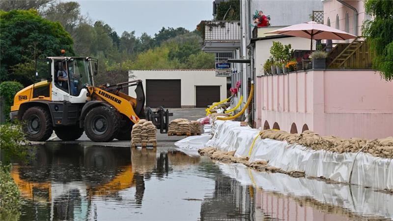 Ein Sandsack-Wall wird in einem Stadtteil von Eisenhüttenstadt verstärkt. Dort hat das Hochwasser Straßen überflutet.