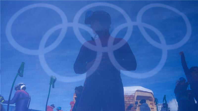 Ein Skifahrer wärmt sich vor dem offiziellen Training für die Abfahrt der alpinen Skifahrer bei den Olympischen Winterspielen 2026 auf.