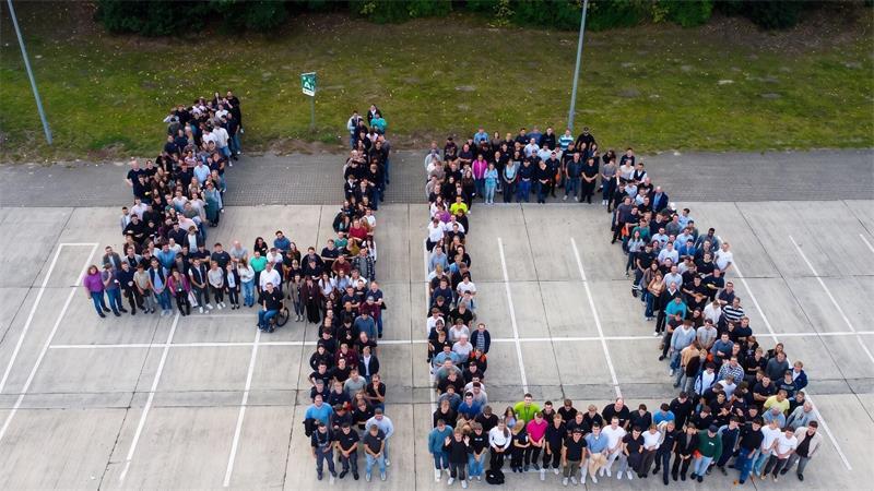 Vom Azubi zum Ausbilder: Einblick in Berufswege bei Airbus in Stade Ein Teil der insgesamt 700 ehemaligen und aktuellen Azubis, die sich zum 40. Geburtstag der Ausbildung bei Airbus in Stade trafen, hat sich für das Foto auf dem Hof aufgestellt.