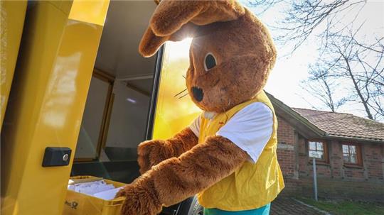 Ein als Hanni Hase verkleideter Mann holt Briefe für das Osterpostamt in Ostereistedt ab.