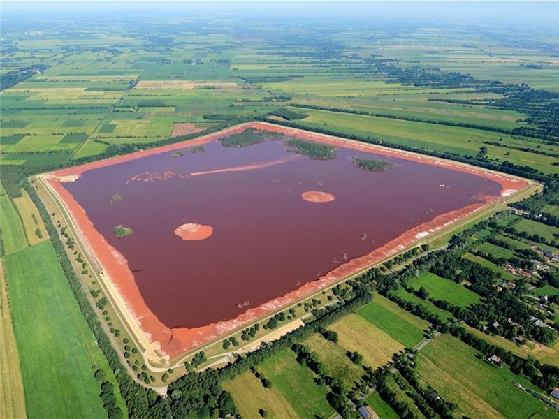 Ein rotes Viereck mitten in der grünen Landschaft: Die Rotschlammdeponie umfasst 146 Hektar . Luftfoto: Martin Elsen