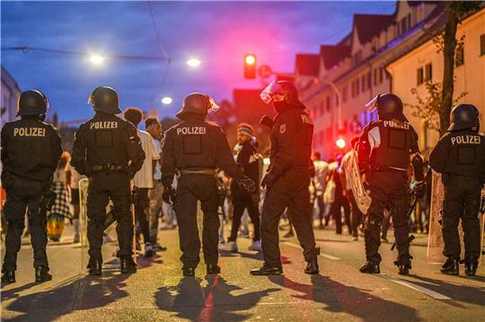 Eine Gruppe von Menschen wird nach Ausschreitungen bei einer Eritrea-Veranstaltung von Polizeikräften eingekesselt.