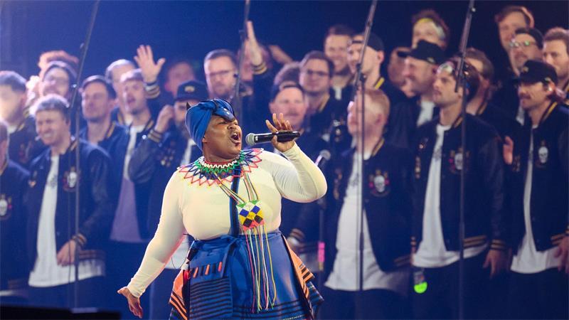 Hamburger Goldkehlchen verabschieden sich mit Weltrekord Eine Sängerin vom Lesedi Showchoir singt auf der Bühne.