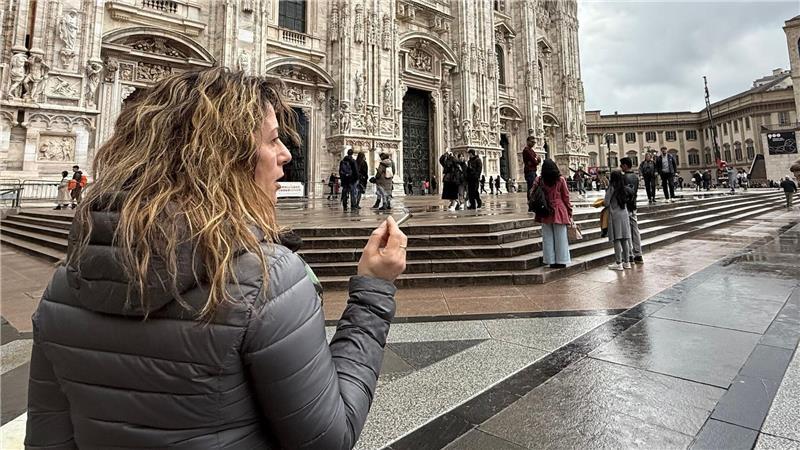 Mailand hadert mit seinem Draußen-Rauchverbot Eine Touristin mit Zigarette in der Hand vor dem Dom in Mailand.