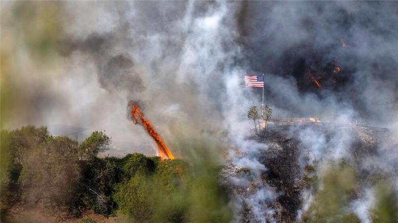Trump ätzt über Brandbekämpfung - 16 Tote bei Feuern in LA Eine amerikanische Flagge weht über einem Teil des Mandeville Canyon