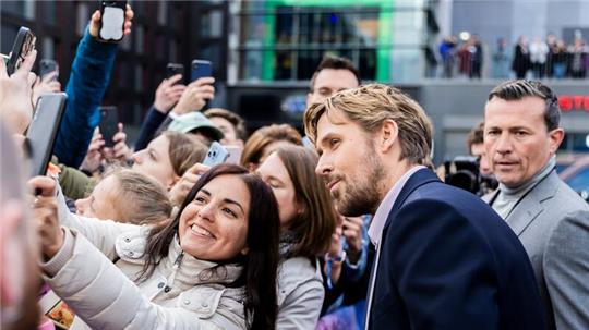 Einmal lächeln: Ryan Gosling posiert für ein Foto mit einem Fan. Der Schauspieler ist mit seiner Kollegin Emily Blunt für die Europapremiere der Actionkomödie „The Fall Guy“ nach Berlin gekommen.