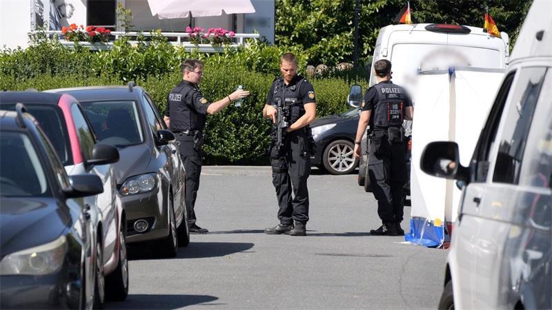 Einsatzkräfte der Polizei stehen in Bremen auf der Straße, auf der ein Mann mit tödlichen Stich- und Schnittverletzungen gefunden wurde. (Archivbild)