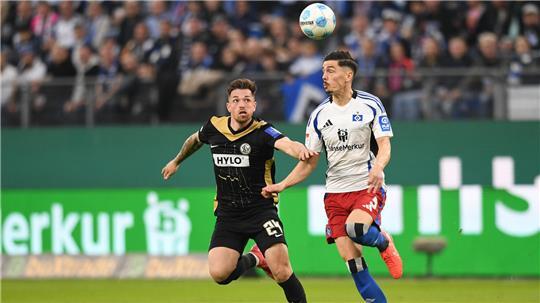 Elversbergs Luca Schnellbacher (l) und Hamburgs Dennis Hadzikadunic kämpfen um den Ball.