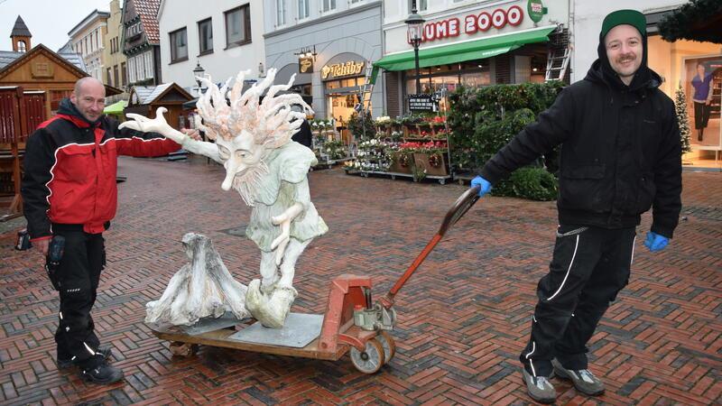 Enrico Frenzel (links) und sein Kollege bringen Märchenfiguren für den Weihnachtsmarkt in Buxtehude. Auf dem Bild transportieren sie die Figur Rumpelstilzchen in die Fußgängerzone.