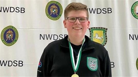 Felix Veichtlbauer steht auf einem Siegerpodest mit Goldmedaille um den Hals.