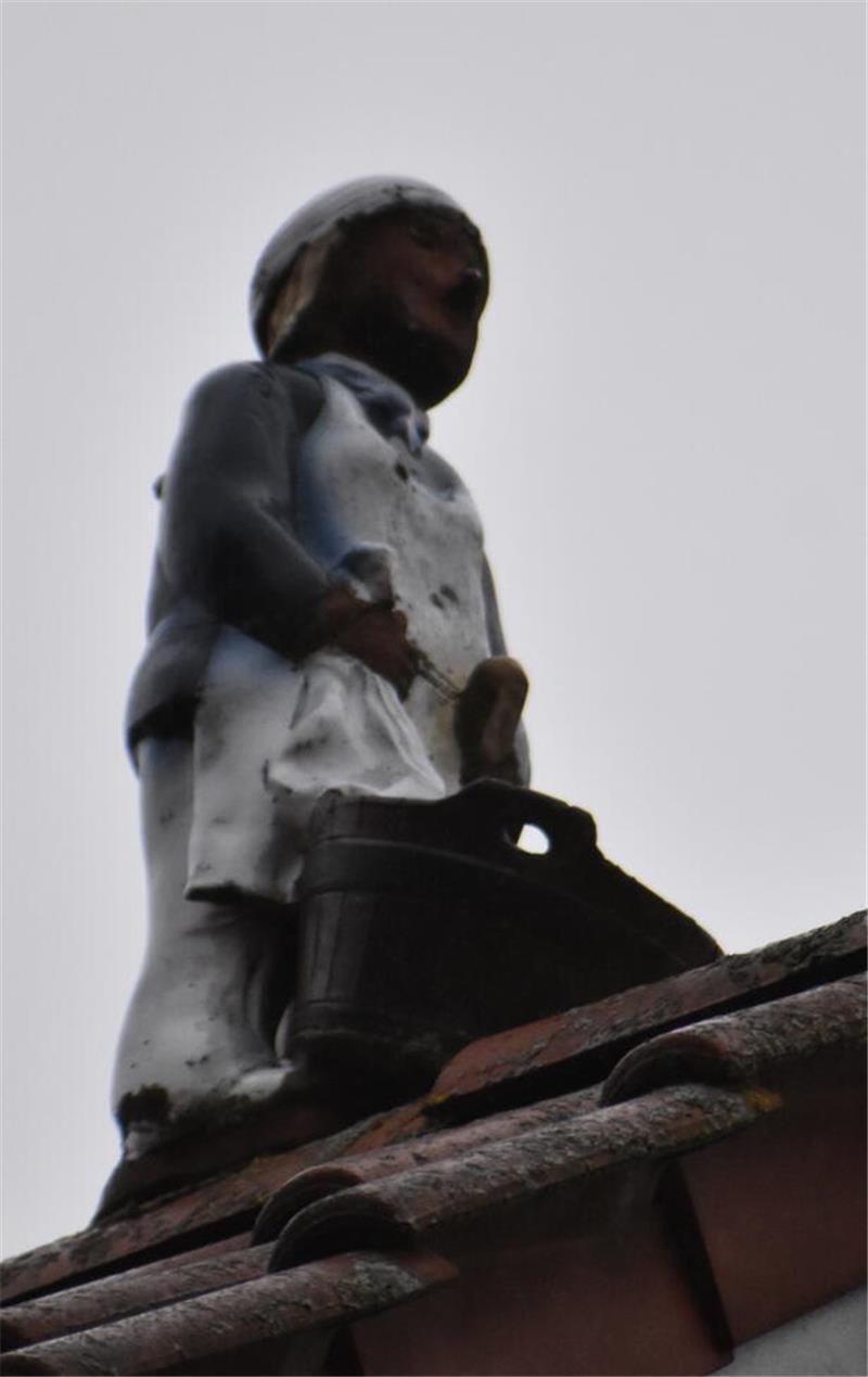 Figur auf dem First: Der Bader mit Bottich erinnert daran, dass an der Holzstraße mal ein Badehaus lag.