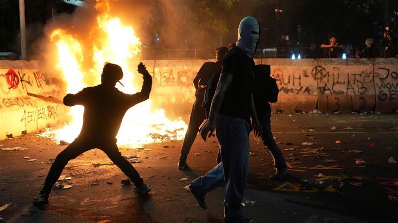Flammender Protest: Demonstranten bewerfen die Polizei mit Steinen bei einer Kundgebung gegen die aktuelle Haushaltspolitik von Präsident Prabowo in Indonesien. 