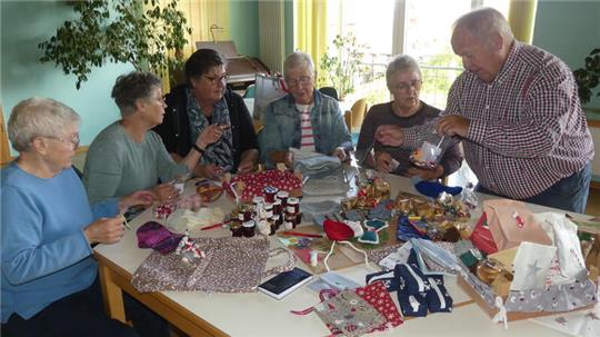 Fleißige Hände füllen im Drochterser Gemeindehaus Adventskalender für Seeleute: Elsbe Mohrmann, Uschi Rieke, Anke Paulini, Anni Ritter, Petra Möller und Drochtersens Küster Riko Baumgarten.