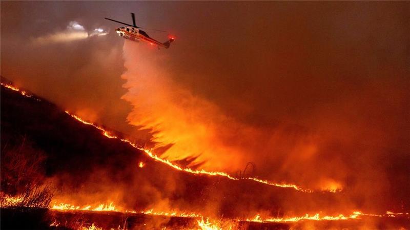 Flug durch das Inferno: Ein Hubschrauber wirft Wasser auf das Kenneth-Feuer in den West Hills von Los Angeles. 