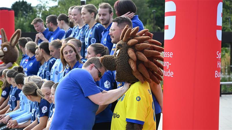 Warum die BSV-Spielerinnen schon im Sommer Weihnachtsmützen tragen Für das Mannschaftsfoto posiert der BSV zusammen mit seinen Maskottchen vor der Halle Nord.