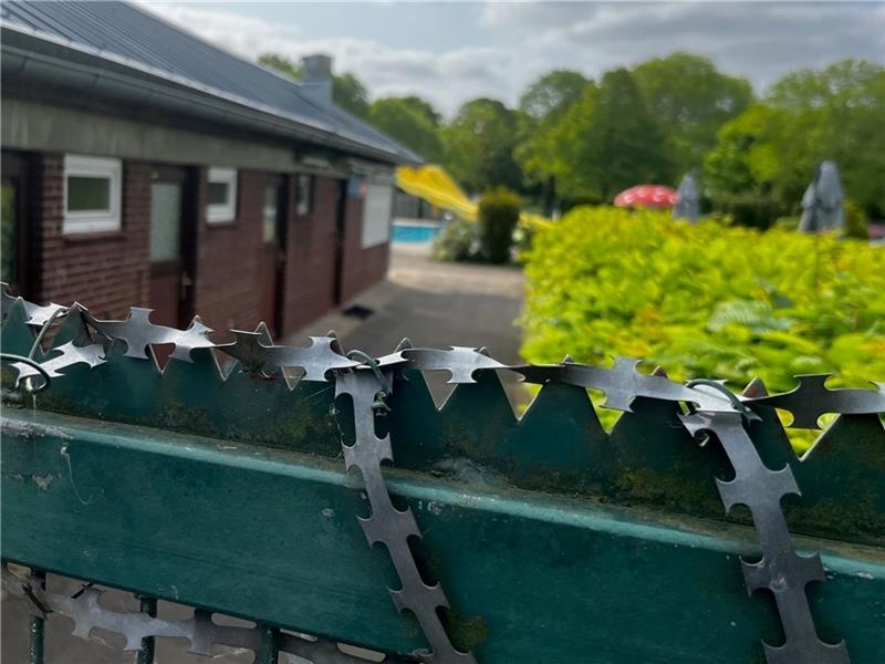 Freibad auf? Jetzt gibt es doch noch eine Chance für Bützfleth Gesperrt und mit Nato-Draht gesichert: Tor zum Bützflether Freibad. Fotos: Richter