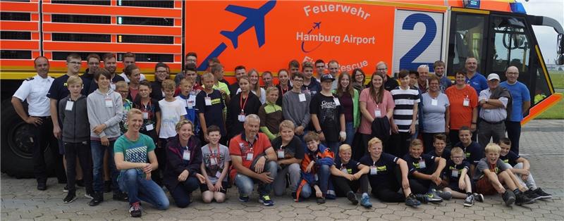 Gruppenfoto vor dem großen Flugfeld-Löschfahrzeug: Die Jugendfeuerwehren sind zu Besuch bei der Flughafen-Feuerwehr in Hamburg. Foto Feuerwehr