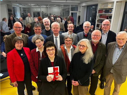 Gudrun Fiedler mit dem Stader Jahrbuch sowie Kollegen und Weggefährten nach der Präsentation im Landesarchiv. Foto: Richter