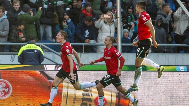 Hannovers Marcel Halstenberg (links) jubelt nach seinem Tor zum 2:1 mit Hannovers Lars Gindorf und Hannovers Nicolo Tresoldi.