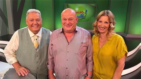 Heiko aus Hemmoor strahlt vor Freude nach seinem Gewinn in der NDR-Show „Bingo! – Die Umweltlotterie“, flankiert von den Moderatoren Michael Thürnau und Ilka Petersen.