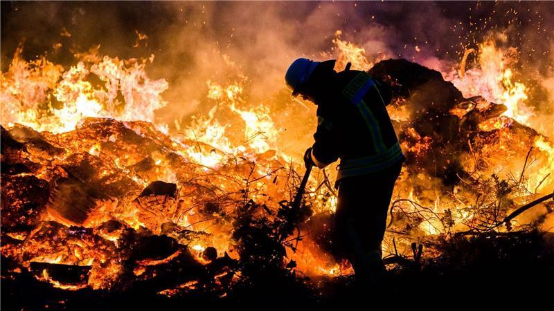 Wo Osterfeuer im Land lodern – ein Überblick für Besucher Hier schichten Feuerwehrkräfte ein traditionelles Osterfeuer im Landkreis Hildesheim auf. (Archivbild)