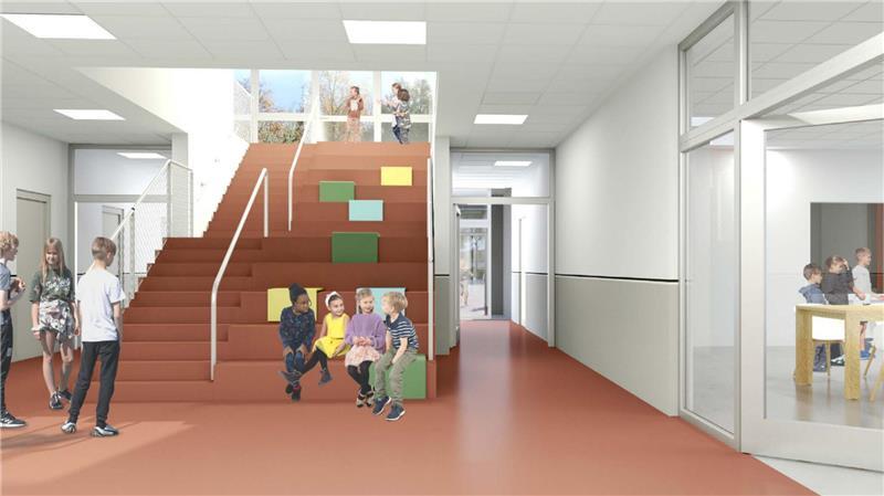 Hinter der Treppe befindet sich der Haupteingang. Von oben flutet Licht die Pausenhalle im neuen Gebäude.