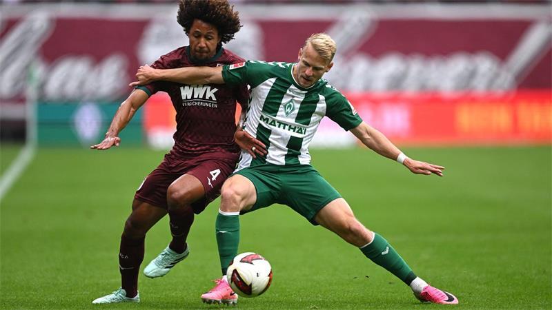 3:2 nach 0:2: Später Werder-Wahnsinn Im Zweikampf: Han-Noah Massengo vom FC Augsburg (l) und der Bremer Marco Grüll.