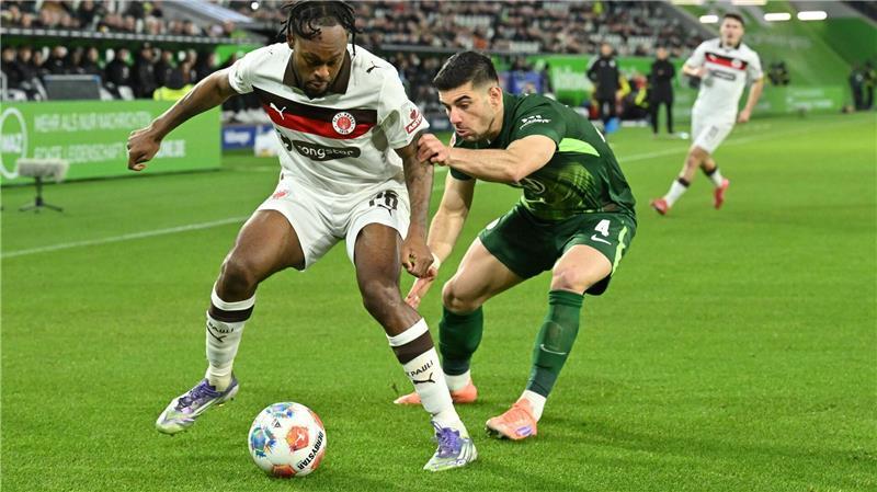 Eriksens erstes Tor: Wolfsburg schlägt Nordrivalen St. Pauli Im Zweikampf: St. Paulis Ricky Jade-Jones (l) und Wolfsburgs Konstantinos Koulierakis.