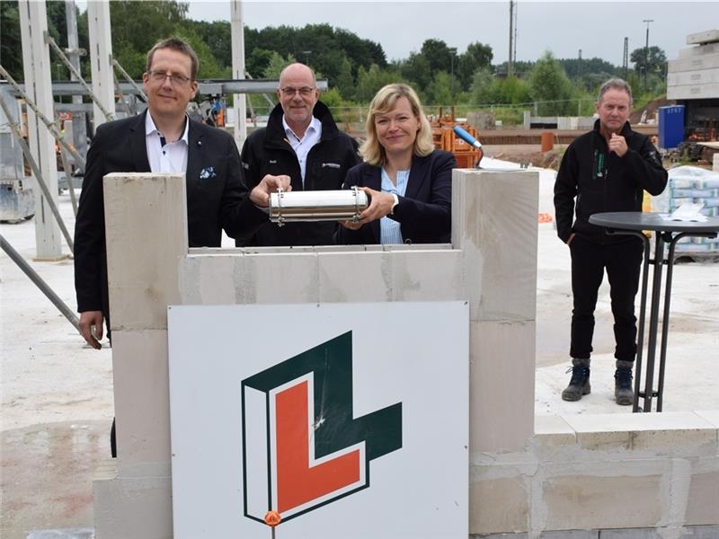 In Aktion: Marco Noetzelmann und Dr. Anja Wode vom Jobcenter. Klaus Detje (dahinter) und Bauleiter Reiner Werner (rechts) von Lindemann beobachten die Szene. Foto: Strüning