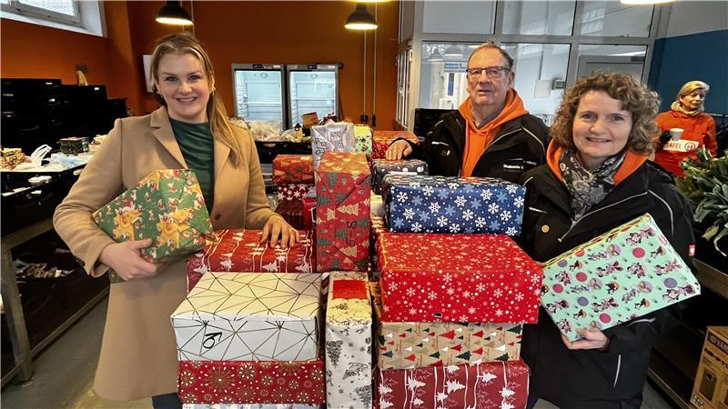 In der Ausgabe der Stader Tafel am Schwingedeich stehen Alexa Afschartabbar, Dietmar Otto und Rabea Spark an dem Turm mit 170 Geschenken, den Schüler der Jobelmannschule gepackt haben.