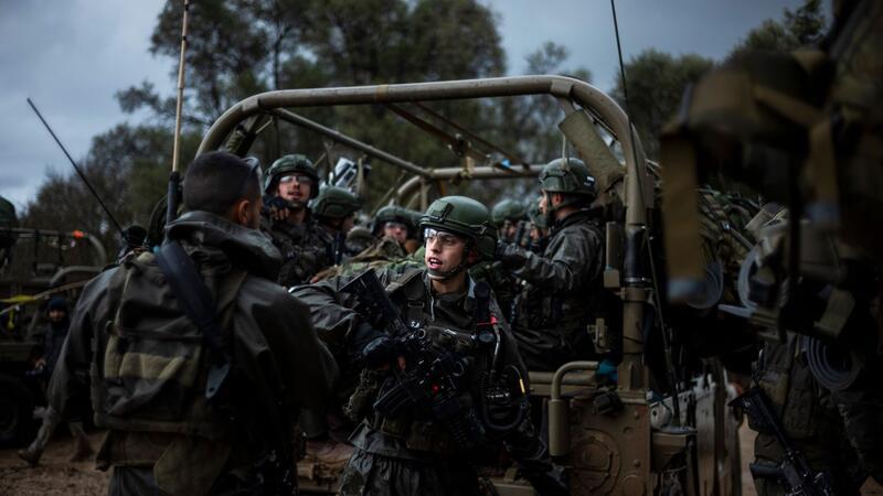 Druck auf Israel zu Zurückhaltung im Gaza-Krieg wächst Israelische Soldaten sitzen in einem Militärfahrzeug an einem Sammlepunkt nahe der Grenze zum Gazastreifen.