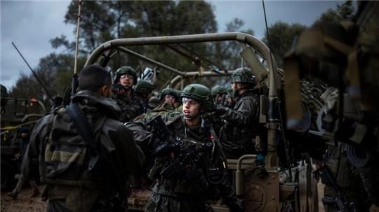 Israelische Soldaten sitzen in einem Militärfahrzeug an einem Sammlepunkt nahe der Grenze zum Gazastreifen.