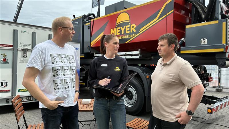 Auf Mission in Hannover: Buxtehuder Wasserretter rüsten sich Jan Blanke (links) und Tobias Krenz von der DLRG-Ortsgruppe Buxtehude im Gespräch mit Stephanie Krempin von Heinz Meyer Feuerwehrbedarf aus Rheden.