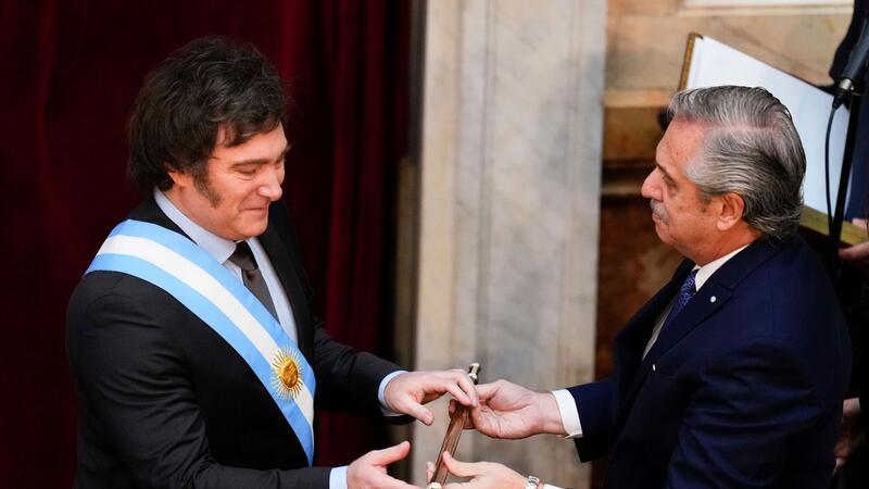 Ultraliberaler Milei als Präsident Argentiniens vereidigt Javier Milei (l) erhält den Präsidentenstock von seinem Amtsvorgänger Alberto Fernandez.