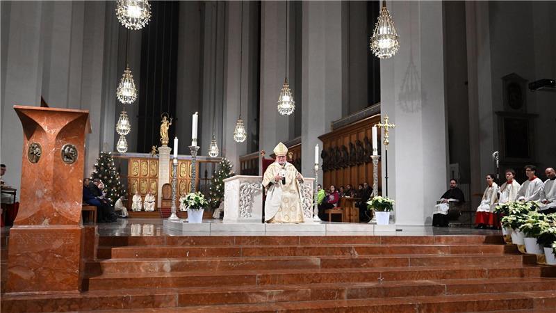 Kardinal Reinhard Marx sitzt im Münchner Dom vor dem Altar.