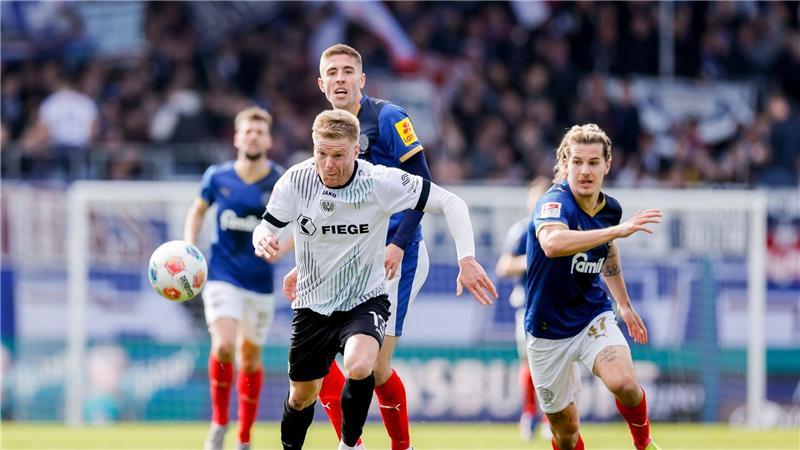 Kieler und Münsteraner Spieler kämpfen um den Ball.