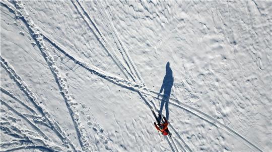 Lange Schatten im Schnee - Wintersportler an der Rodelpiste am Wurmberg im Harz
