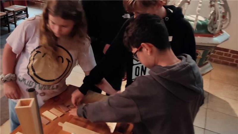 Lebendiger Musikunterricht in der Kirche mit einem Miniaturmodell der Orgelakademie Stade.