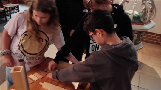 Lebendiger Musikunterricht in der Kirche mit einem Miniaturmodell der Orgelakademie Stade.