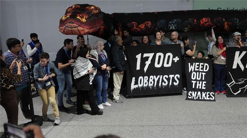Party der Öl-Industrie? 1.700 Lobbyisten auf Klimagipfel Lobbyisten als böse Schlange: Aktion von Klimaaktivisten auf der COP29.