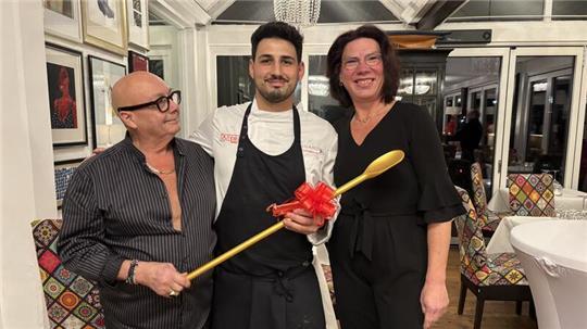 Manuela Gubbels hat das Restaurant Al Porto von Familie Zonca gekauft. Sandro Zonca übergab kürzlich symbolisch den goldenen Kochlöffel an den neuen Koch Raffaele Ben Abdelouahed.