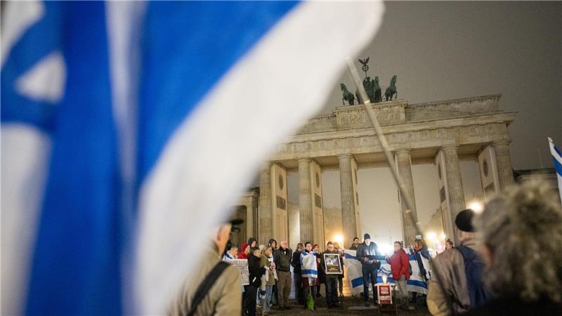 Menschen erinnern am Brandenburger Tor an die Opfer des 7. Oktober.