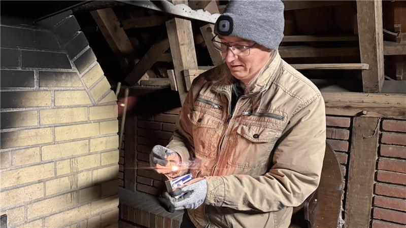 Michael Hinrichs entzündet das erste Streichholz, um den Backofen anzufeuern.