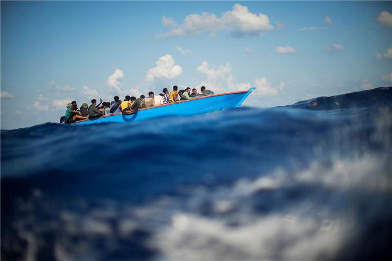 Über 180.000 Migranten flüchteten 2023 übers Mittelmeer Migranten sitzen in einem Holzboot südlich der italienischen Insel Lampedusa auf dem Mittelmeer.