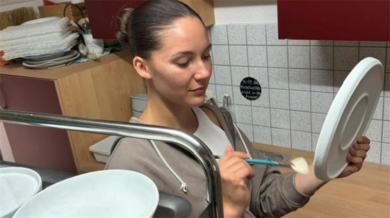 Mitten in der Krise: Zwei junge Frauen machen sich in Buxtehude selbstständig Milena Meyer glasiert einen Teller. Damit erhält die Keramik eine feine, schützende Schicht.