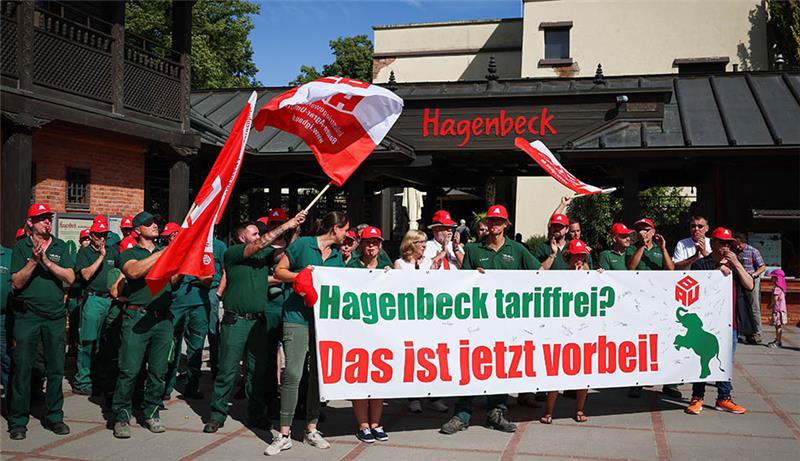 Mitarbeiter des Hamburger Tierparks Hagenbeck stehen bei einem Warnstreik vor dem Eingang des Zoos. Die Industriegewerkschaft Bauen-Agrar-Umwelt (IG BAU) hat die Angestellten zu dem zweistündigen Warnstreik aufgerufen um unter anderem über bessere Konditionen bei den Arbeitszeiten, Zuschlägen und Urlaubstagen zu verhandeln. Foto: Christian Charisius/dpa