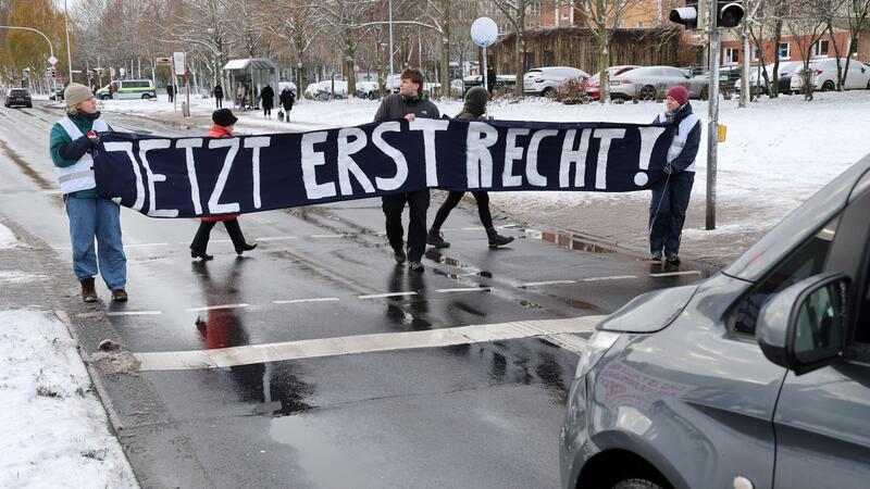 Klimaaktivisten von Straße gezogen - Fahrer verurteilt Mitglieder der „Letzten Generation“ blockieren während des Prozesses eine Straße.